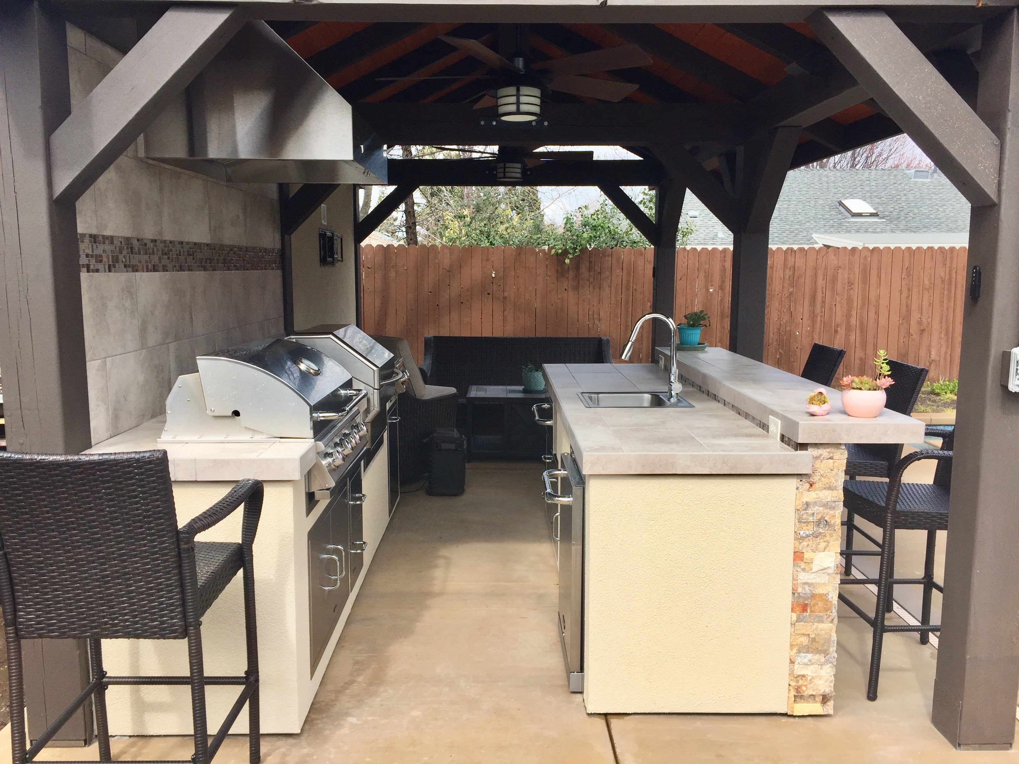 outdoor kitchen under brown pergola